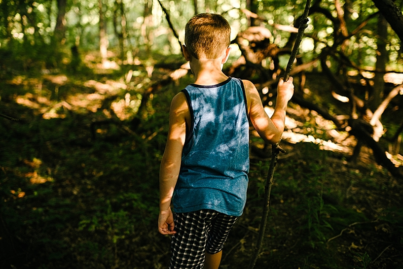 boy walking through the woods