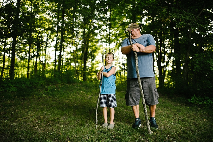 dad and son in the woods with walking sticks