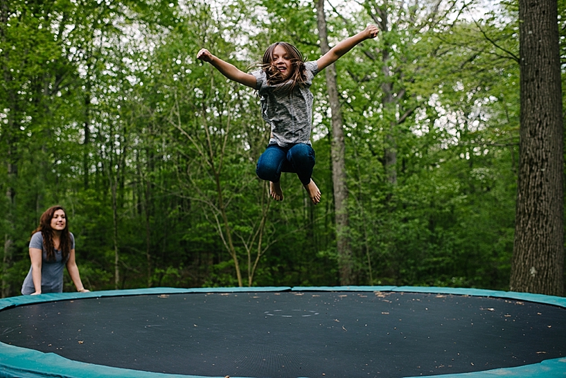 little girl jumping on trampoline