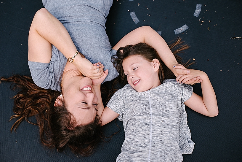 Mom and daughter laying on trampoline