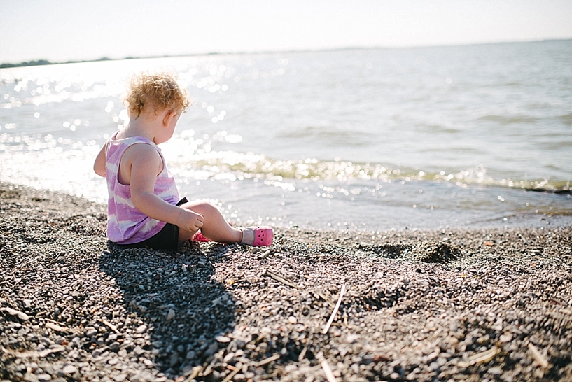 toddler girl sitting on the beach of Lake Erie