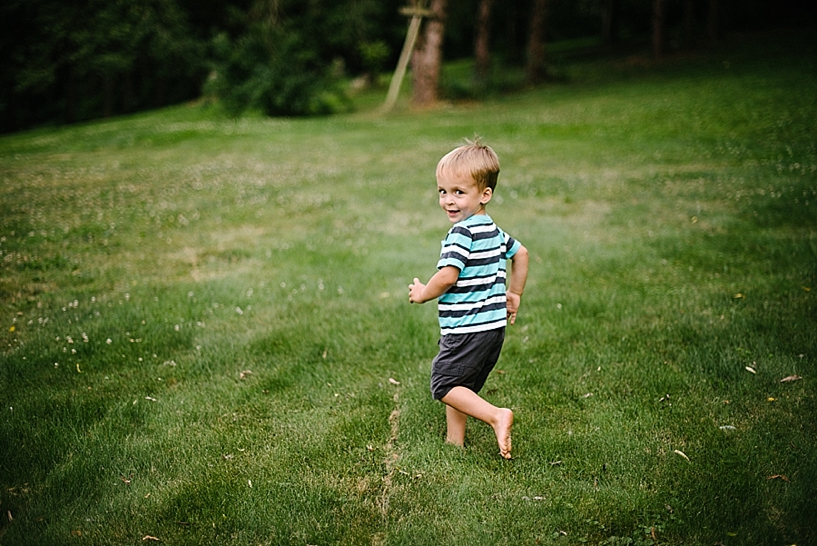 little boy running across backyard