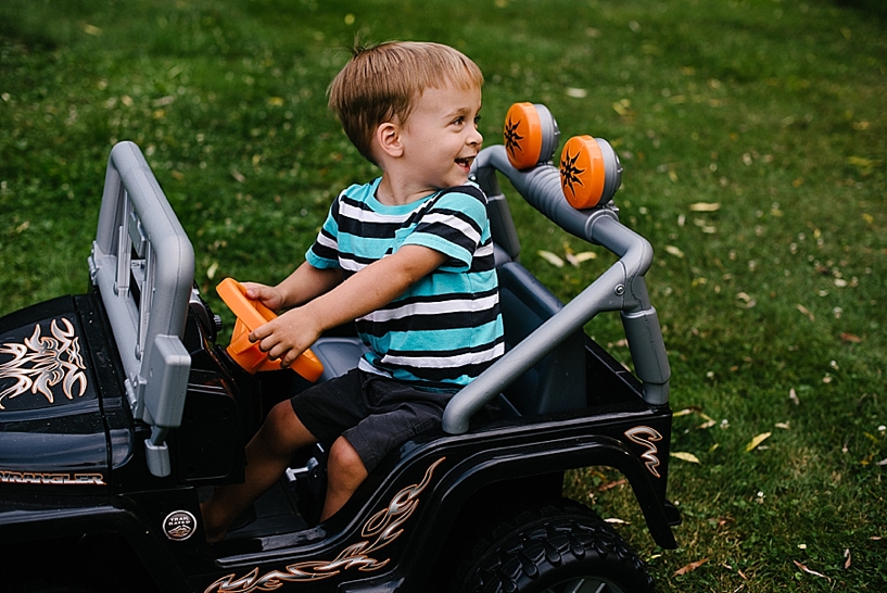 boy riding his toy jeep
