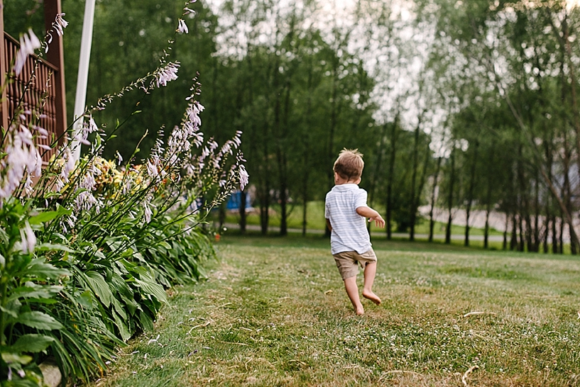 little boy running by the garden 