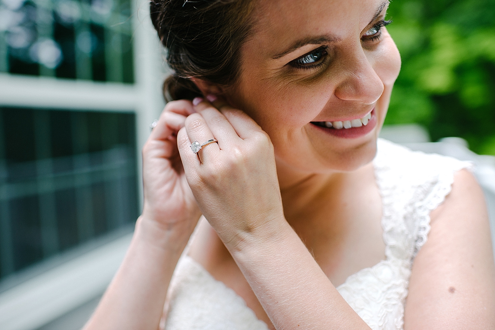 bride smiling and putting in earring