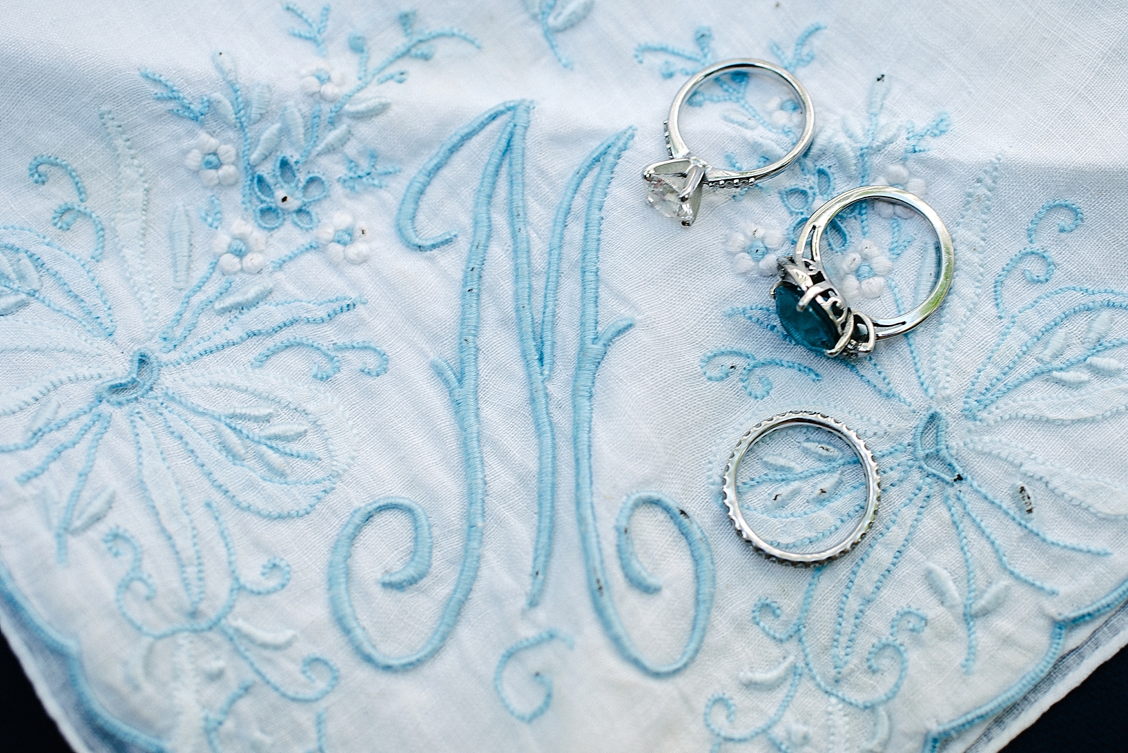 blue and white embroidered handkerchief with wedding rings