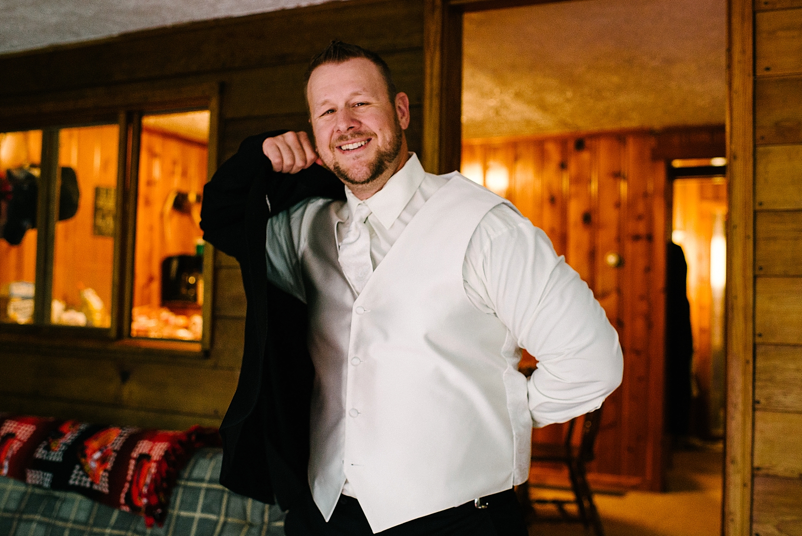 groom putting his tux jacket on