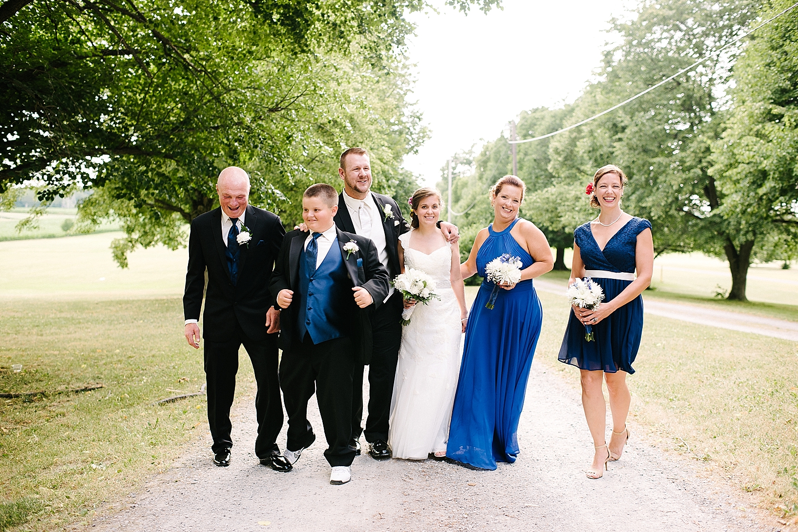 bridal part standing on country dirt road