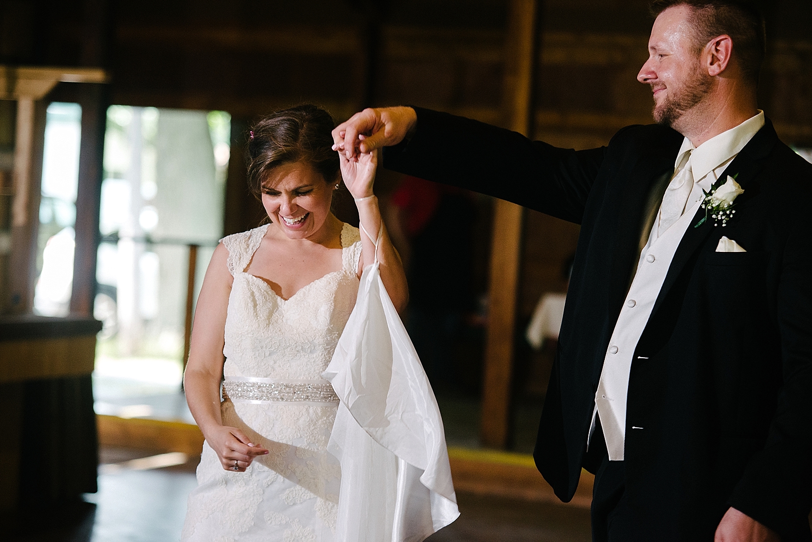 groom twirls bride on the dance floor