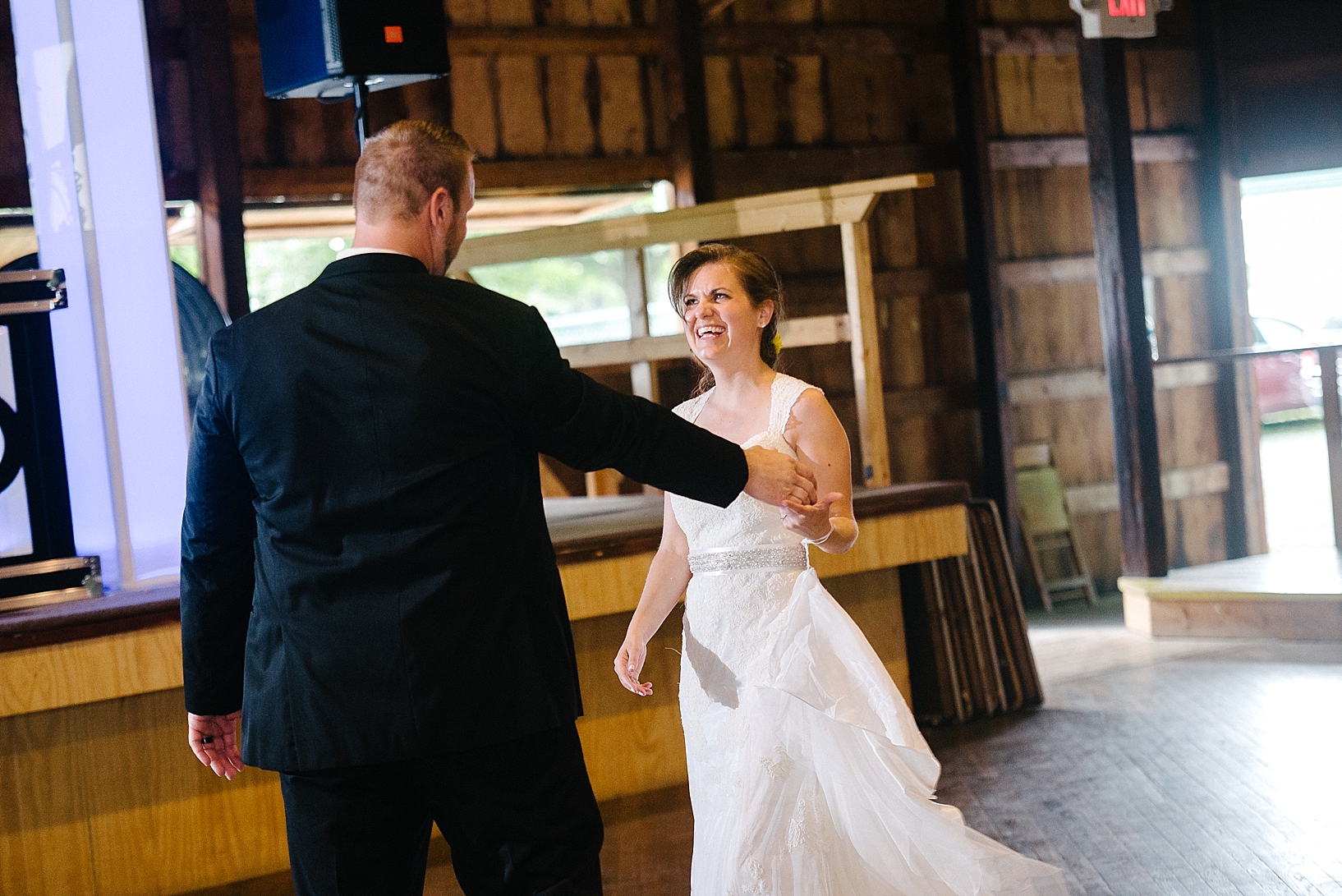 groom twirls bride on the dance floor