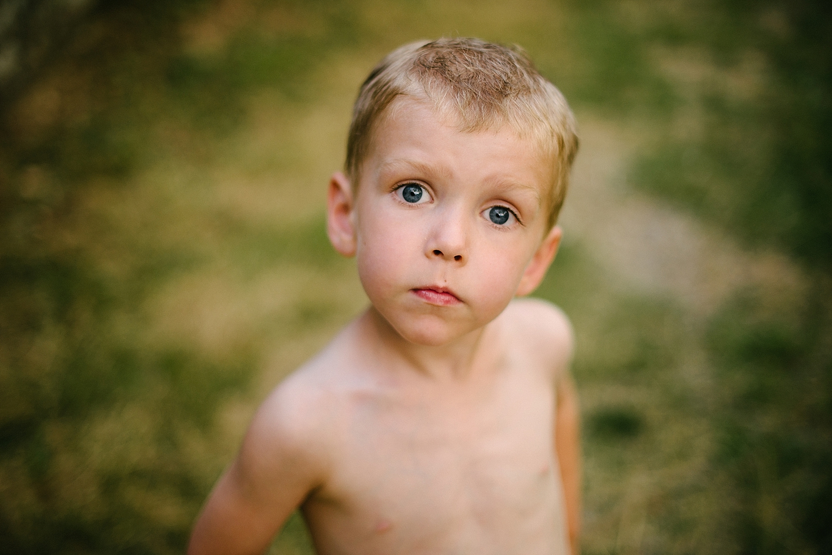 little boy with blue eyes with no shirt