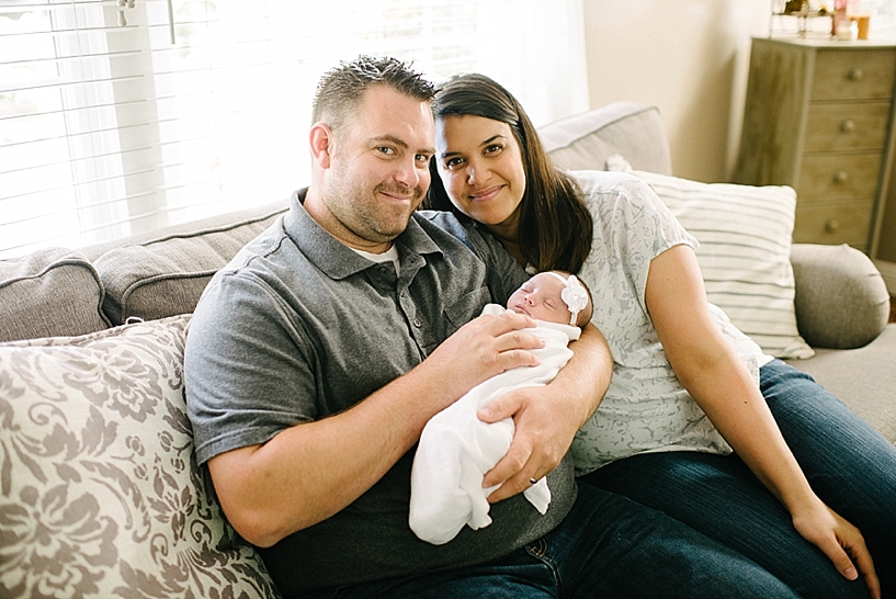 parents holding newborn daughter