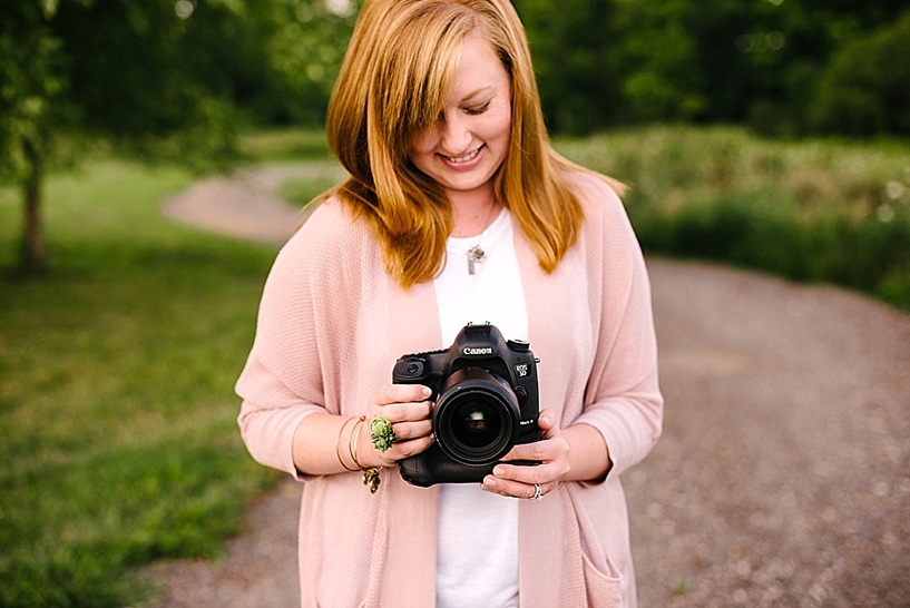 redheaded woman holding a Canon 5D Mark