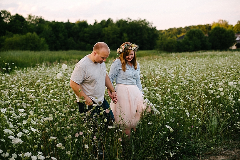 couple standing in field of Queen Anne's Lace