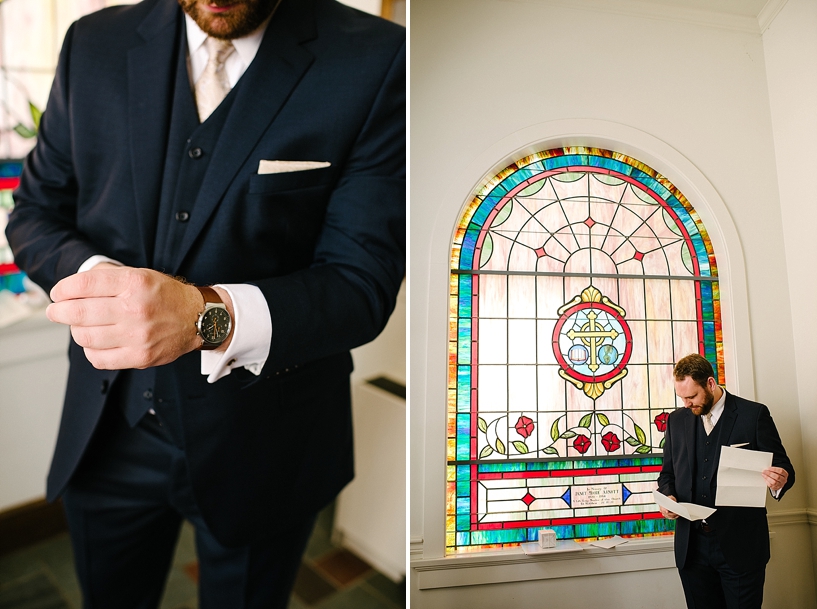 groom reading letter from bride by stained glass window