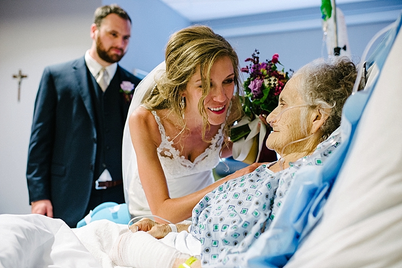 bride smiling at grandmother in hospital bed