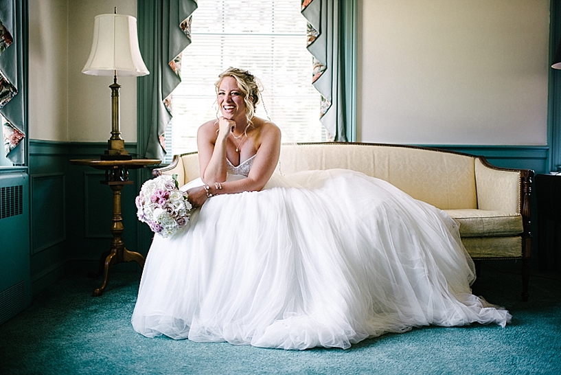 bride in poofy gown sitting on couch