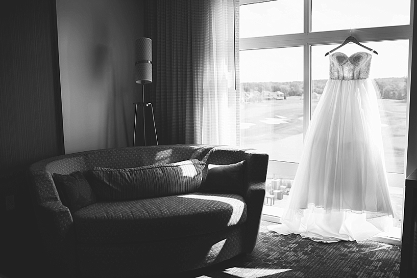wedding dress hanging on hotel room window
