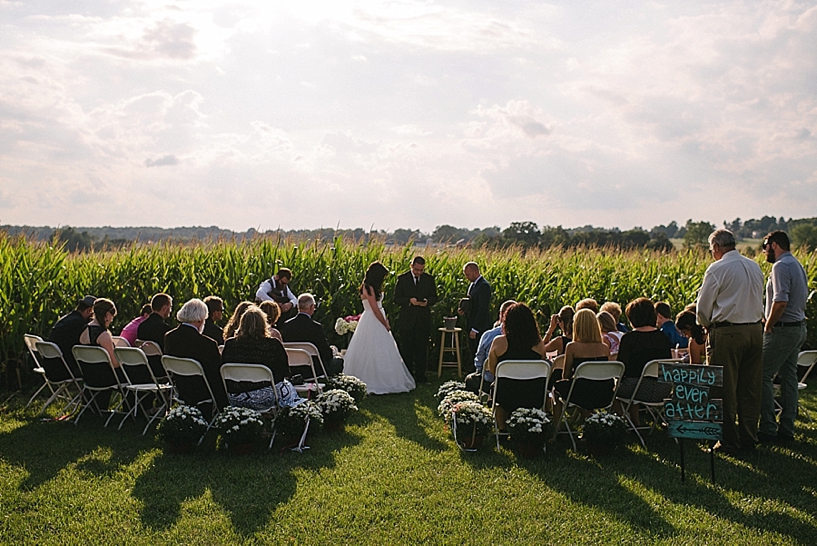 wedding ceremony in front of corn field
