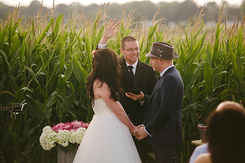 officiant praying over bride and groom
