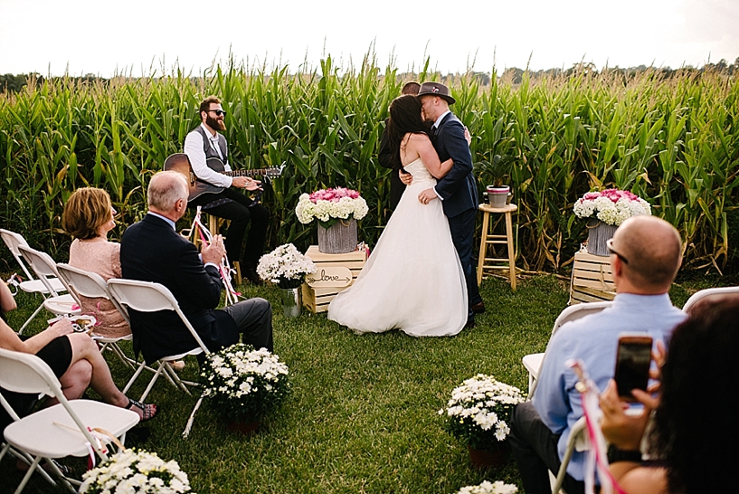 bride and groom share first kiss during ceremony