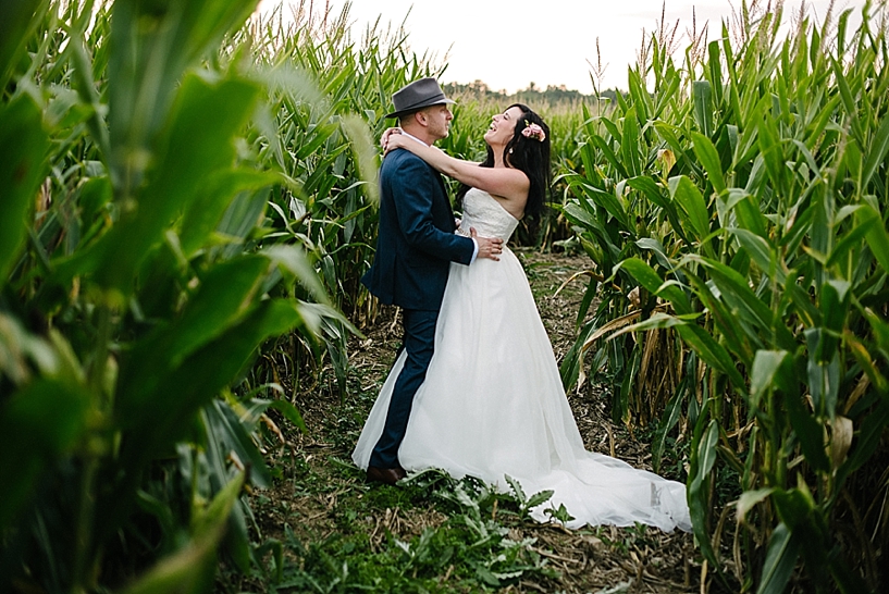 bride and groom dancing in corn maze