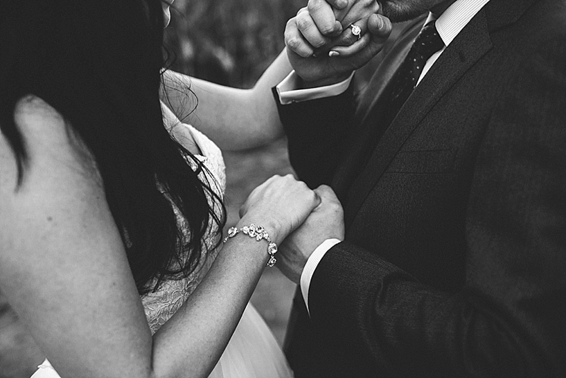 groom kissing bride's hand