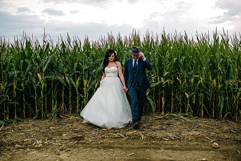 bride and groom walking in corn maze