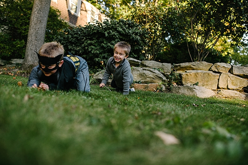 two brothers crawling across front yard
