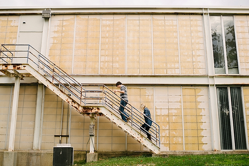 guy and girl walking up the fire escape on the back of yellow art building on Kent State University
