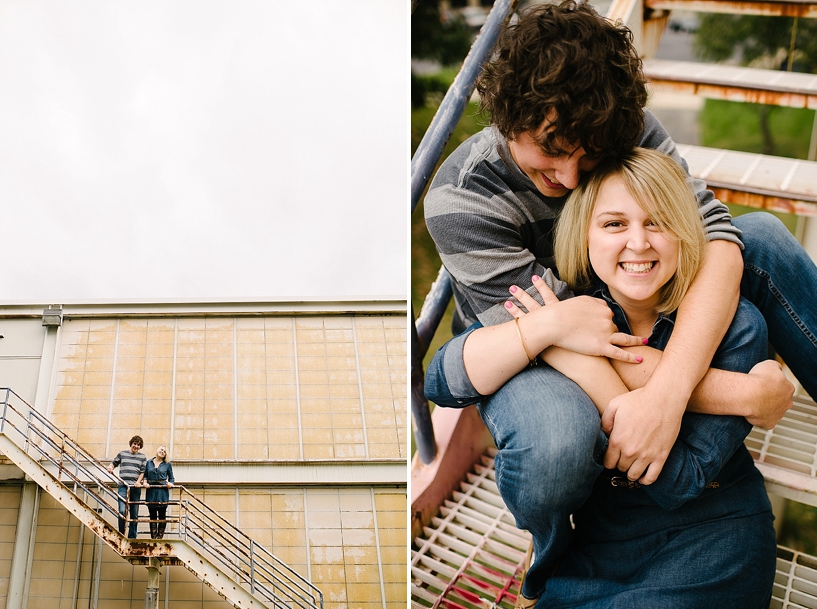 blonde girl in denim dress and guy in jeans and grey striped sweater on fire escape of yellow building