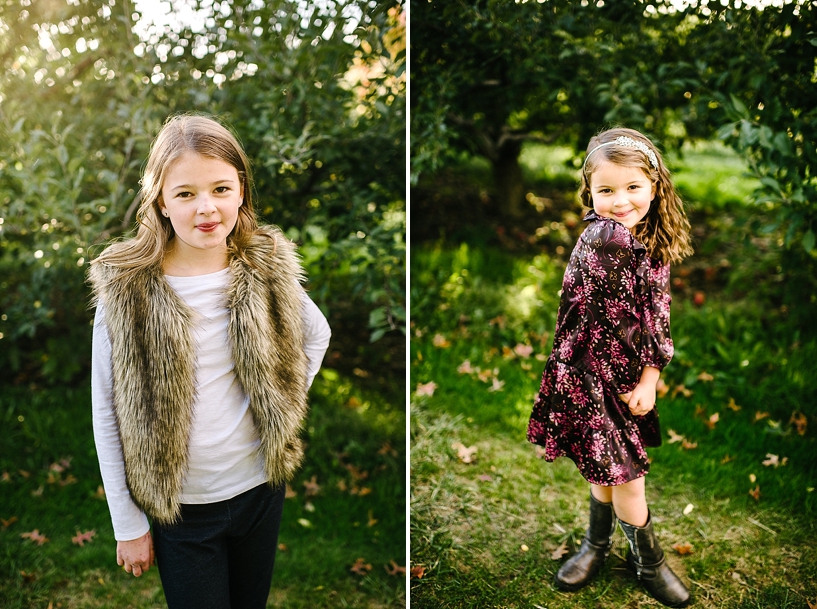 sisters standing in apple orchard
