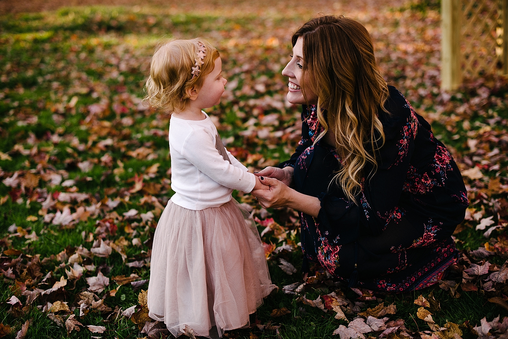 redhead toddler wearing pink tutu smiling at mom with ombre hair