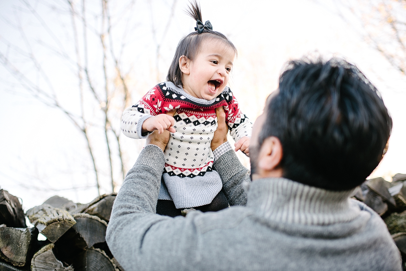 dad tossing daughter up in the air