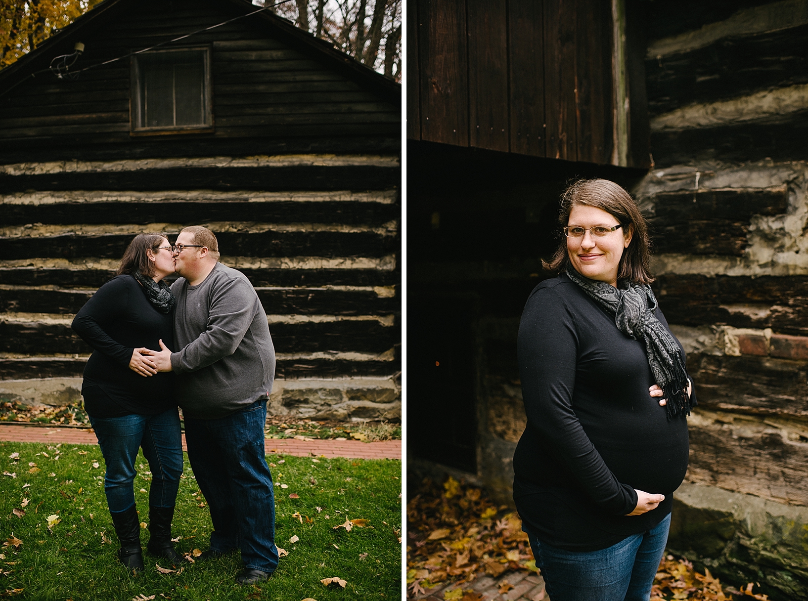 expectant parents standing in front of rustic log cabin kissing