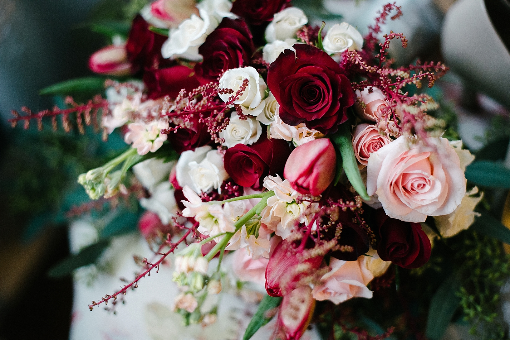winter bridal bouquet with red white and pink roses