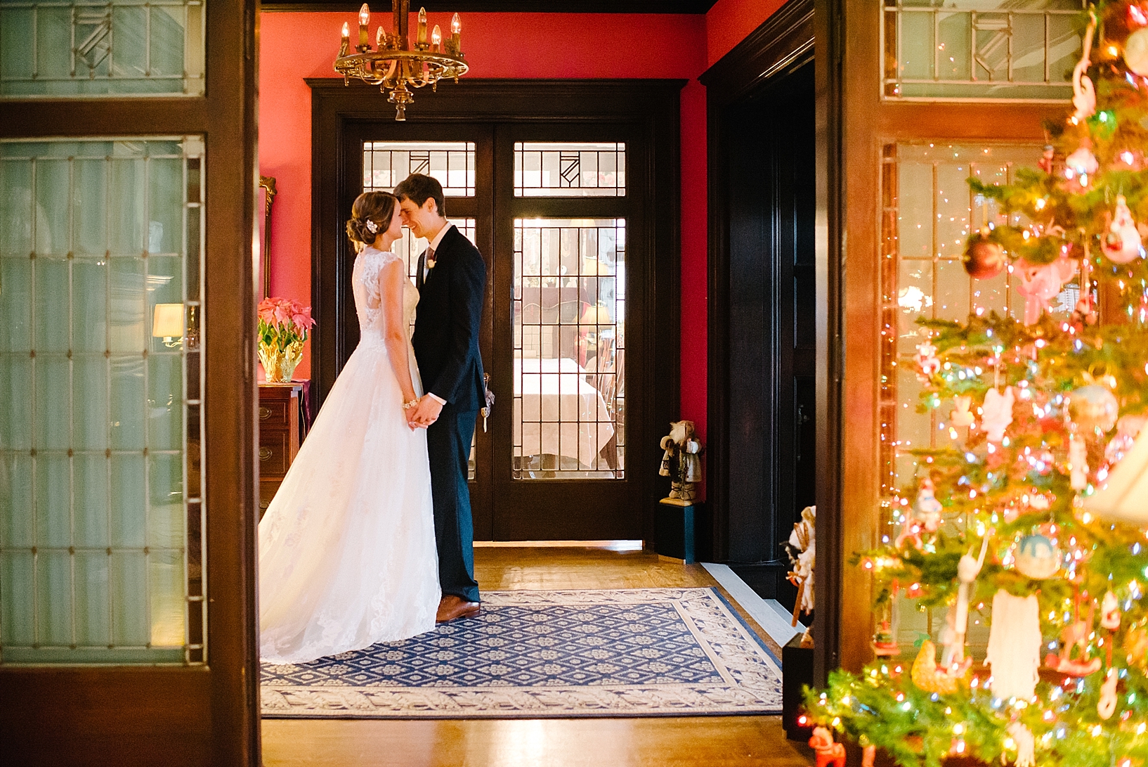 bride and groom standing in lobby of bed and breakfast holding hands and kissing