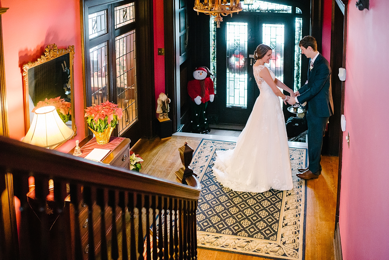 bride and groom see each other for first time in lobby of bed and breakfast