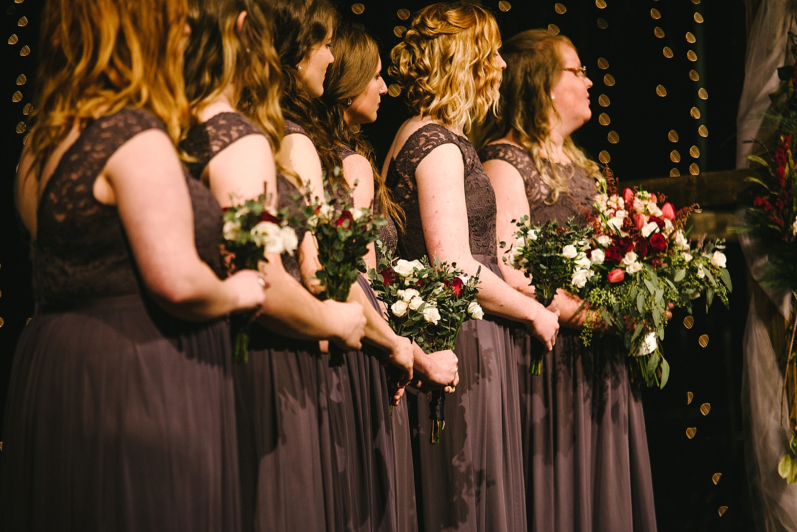 bridesmaids standing at front of church during wedding ceremony