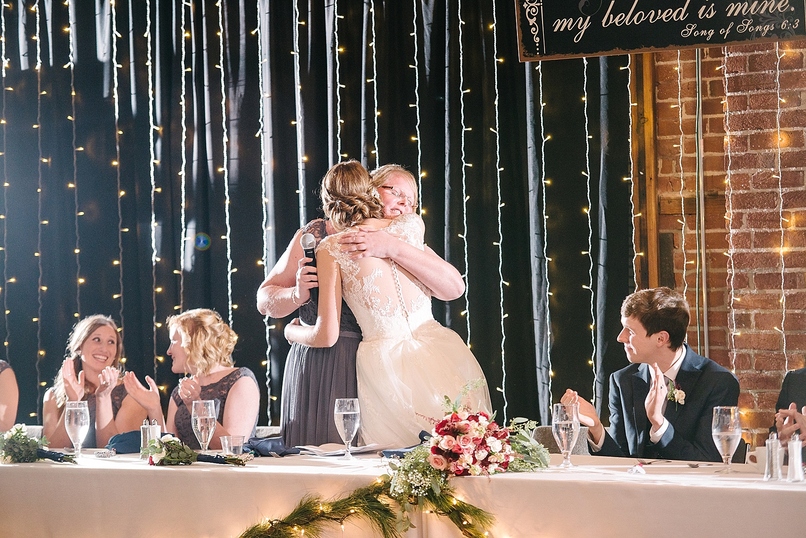 maid of honor hugging bride after giving toast