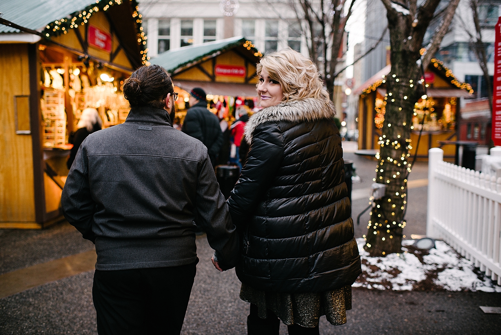 couple walking through PPG place market at Christmas time
