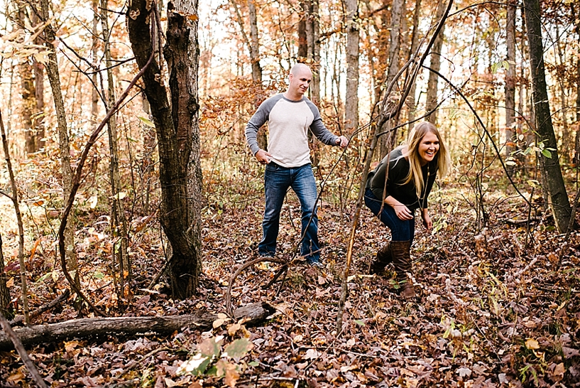 couple walking through woods during autumn
