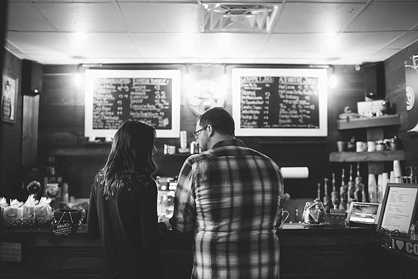 man and woman standing at coffee counter ordering drinks