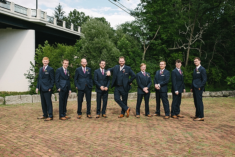 groomsmen in navy tuxes with brown shoes