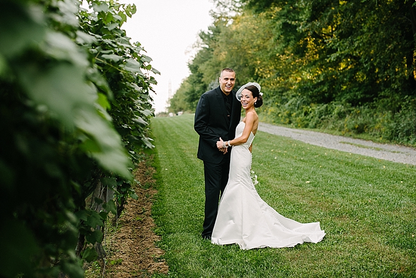 bride and groom standing in vineyards at Gervasi Vineyards Canton OH