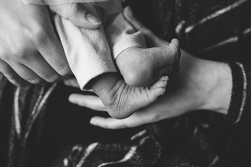 newborn feet in mom's arms