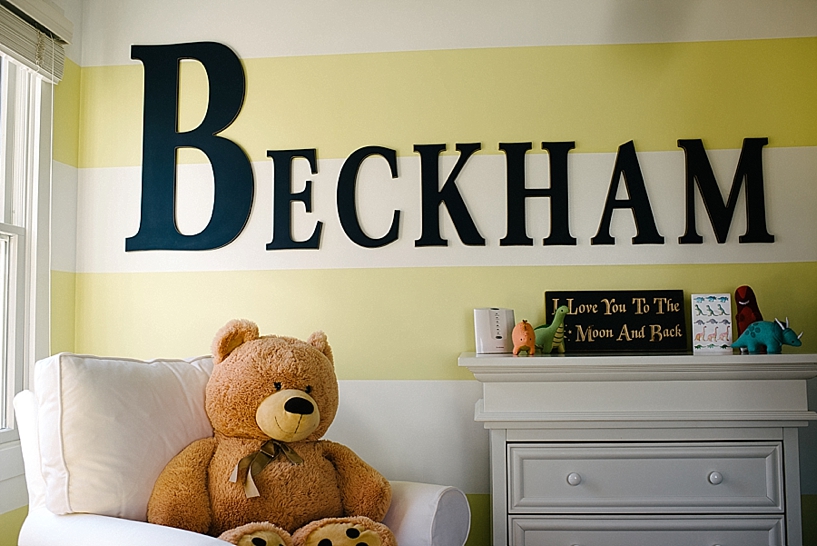 yellow striped bedroom wall with Beckham spelled out in wooden letters