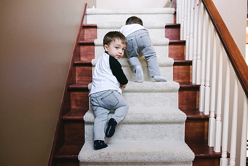 twin brothers climbing up staircase