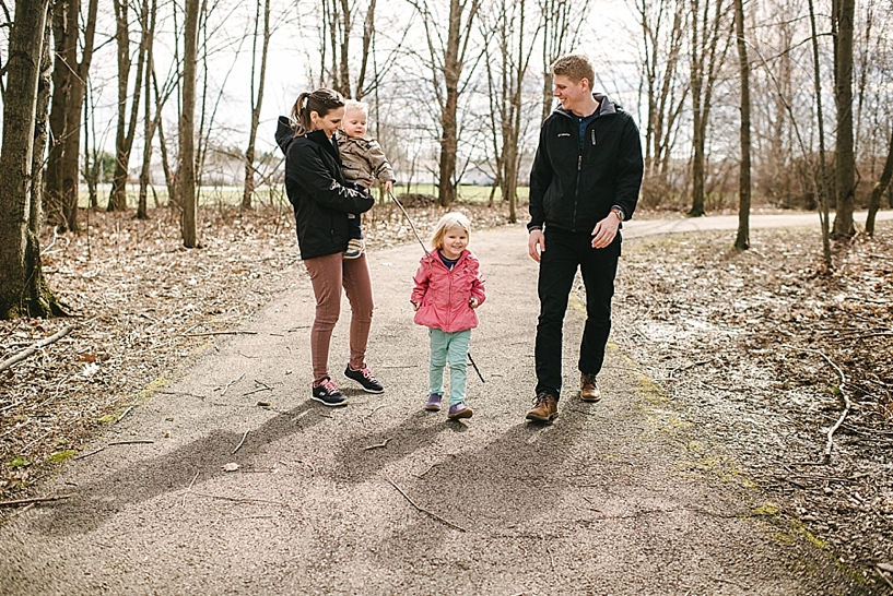 family with young children walking along path through woods