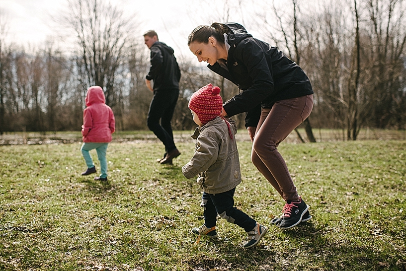 family with young children walking through park